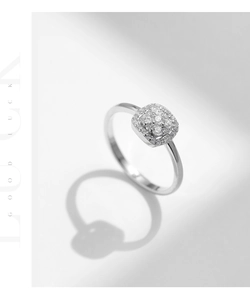 Close-up of a silver S925 square moissanite ring with elegant shadow play and good luck text