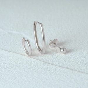 Macro shot of 925 sterling silver hoop earrings set with polished metallic finish