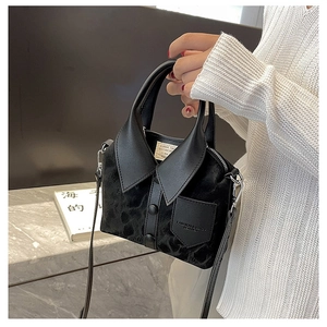 Detailed view of creative shirt-shaped handbag in black velvet and leather blend