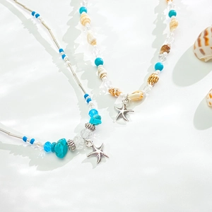 Collier bohème multicouche avec perles turquoise, coquillages et pendentifs étoile de mer