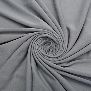 Macro view of grey swaddle blanket fabric showing high elasticity and soft knit texture