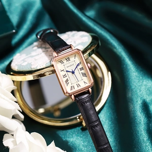 Detail of vintage square ladies watch with rose gold case and black leather texture strap
