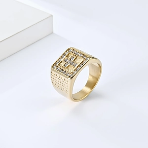 Detailed macro view of 18K gold plated signet ring with iced-out cross and textured band