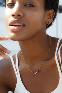 Close-up of a 925 silver 18K gold smile pendant necklace with lapis lazuli on a model