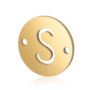 Detail of a golden stainless steel round pendant featuring a cutout letter S and dual holes
