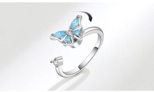 Detail of silver rotating butterfly ring with blue teardrop stones and spinning mechanism