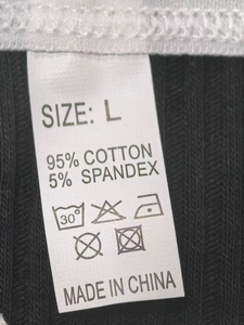 Close-up of garment label showing 95% cotton and 5% spandex blend on ribbed black fabric