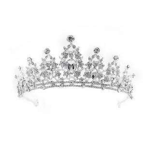 Macro view of detailed vintage silver crown with teardrop rhinestones and floral patterns
