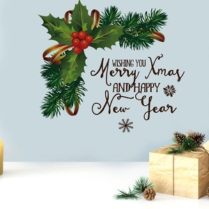 Macro detail of Christmas wall sticker with Merry Xmas lettering and holly berry wreath