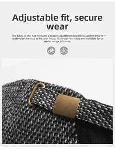 Detail of adjustable bronze metal buckle on textured gray winter baseball cap