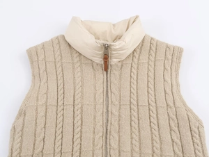 Detail of cable knit vest with stand collar, metallic zipper and leather puller