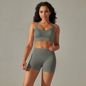 Detailed texture of seamless sage green sports bra and high-waist fitness shorts set