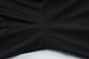 Detailed close-up showing reinforced seams and knit texture of black high-stretch shorts