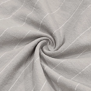 Macro detail of breathable grey linen fabric with white vertical stripes and soft texture