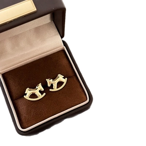 Elegant 18k gold plated rocking horse earrings on a velvet luxury jewelry box