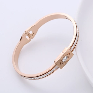 Elegant rose gold Evil Eye bangle with crystal pavé accents and spring clasp