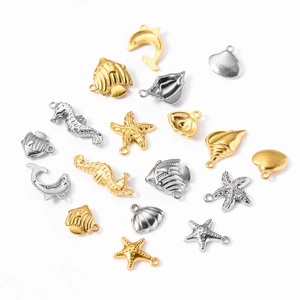Detailed macro view of gold and silver marine theme charms like starfish and seahorses