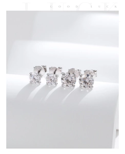 Detail of 925 sterling silver moissanite stud earrings with classic four-prong setting