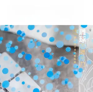 Detailed macro view of semi-transparent nail art stickers with varying blue polka dots