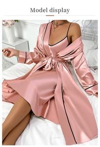 Detail of ice silk pajama set in soft pink with black trim and elegant satin finish