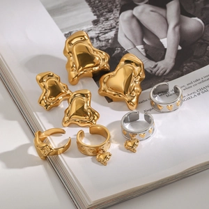 Detailed view of gold and silver heart-shaped jewelry set on a fashion magazine background