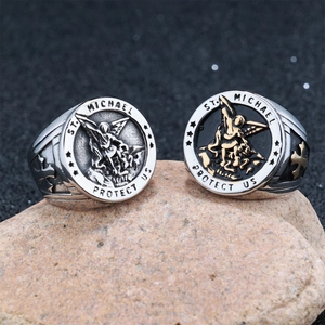 Detail of St. Michael relief rings with engraved protect us text on natural stone