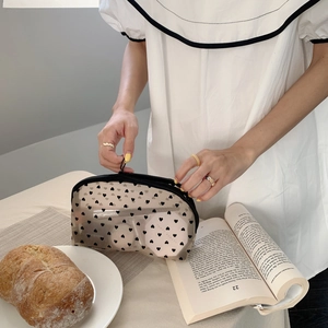 Transparent black mesh makeup bag with heart patterns and zipper for cosmetics storage