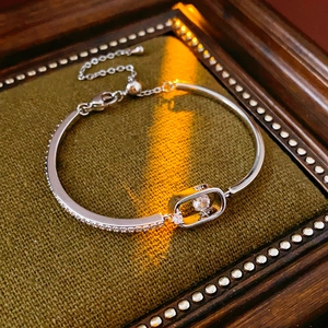 Detail of 18k gold plated silver bracelet featuring sparkling zircon inlay and adjustable slide clasp
