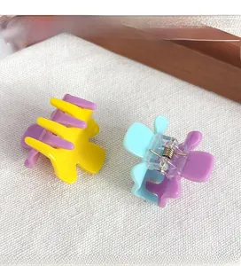Close-up of vibrant candy color acrylic mini hair claws with transparent spring mechanisms