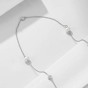 Detailed view of sterling silver chain with freshwater pearls and zircon stones