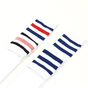 Detail shot of white knee-high socks with striped bands in sporty athletic knit texture