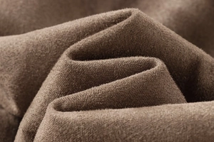 Macro-opname van de hoogwaardige donkerbruine suède textuur van een lange winterjas