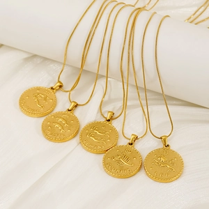 Detail of 18K gold plated zodiac coin necklaces featuring Pisces and Gemini engravings