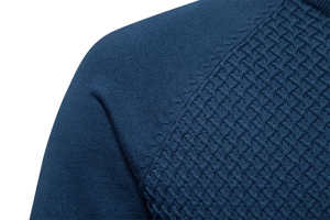 Macro detail of navy blue knitted sweater showing contrast stitching and waffle texture