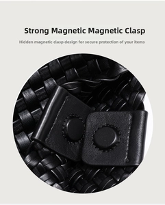 Detail of a black woven bucket bag showing the secure hidden magnetic snap closure system