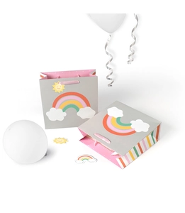 Cartoon rainbow and clouds gift bag with pink rope handles on a white background
