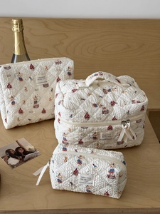 Three-piece quilted makeup bag set with cute circus print in warm beige cotton fabric