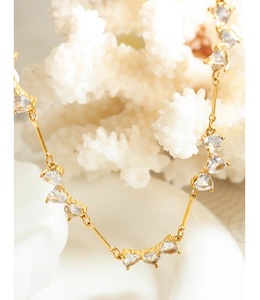 Macro shot of gold-plated titanium necklace with clustered heart-shaped zirconia stones