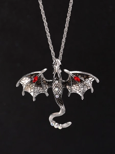 Detail of silver dragon pendant with red crystal wings and sparkling rhinestones