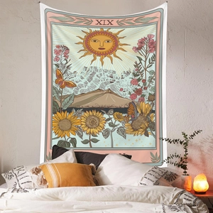 Detail of bohemian Sun Tarot XIX tapestry with sunflowers hanging over a bed headboard