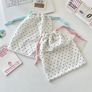 Set of two polka dot drawstring bags with blue and pink cords for cosmetics storage