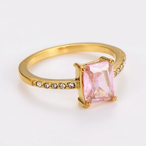 Close-up of golden ring with pink emerald-cut gemstone and small pave-set diamonds