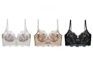 Detailed flat lay of longline lace bras in white, champagne, and black with floral embroidery