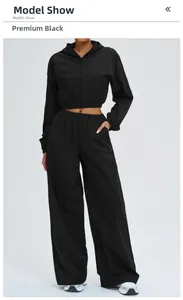 Detail of black hooded zip-up sports set with high-waisted wide-leg athletic pants