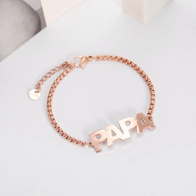 Close-up of rose gold titanium steel chain bracelet with PAPA letter pendant