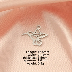 Polished silver hummingbird pendant detail showing exact dimensions on pink silk fabric