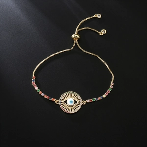 Close-up of golden evil eye bracelet with colorful square zircons and adjustable pull chain