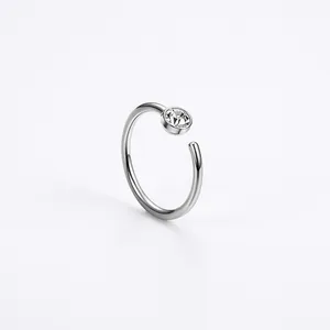 Detail of C-shaped stainless steel nose ring with sparkling round cubic zirconia stud
