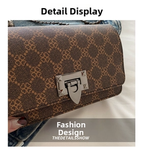 Close-up of brown clover print shoulder bag featuring a silver metal twist lock buckle