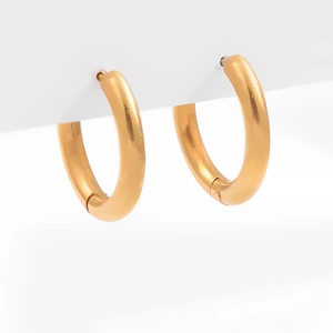 Detailed close-up of polished gold geometric hoop earrings with secure snap closure